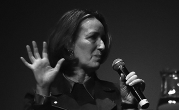 Black and white portrait of woman with microphone talking