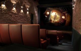 interior of small stone-clad cinema with brown leather seats