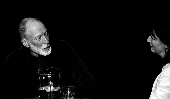 Man with beard in conversation with woman