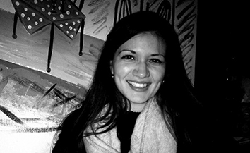 Young woman with long straight dark hair smiling