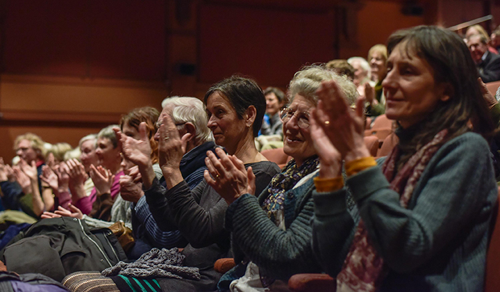 People in an audience applauding