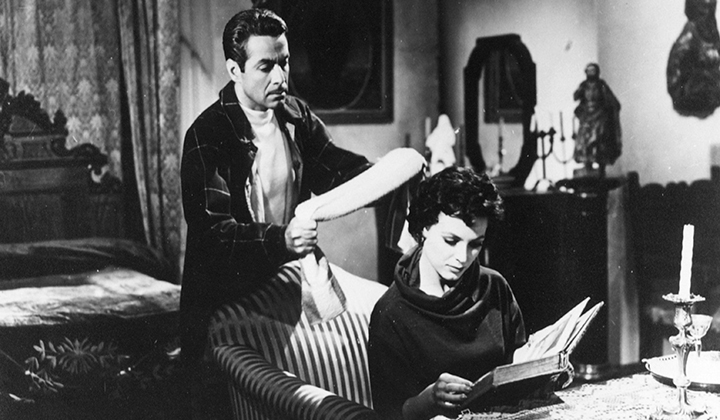 black and white image of man waiting to strangle woman reading a book with his scarf